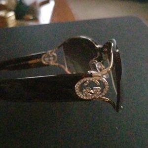 Gucci shades and a coach make-up bag